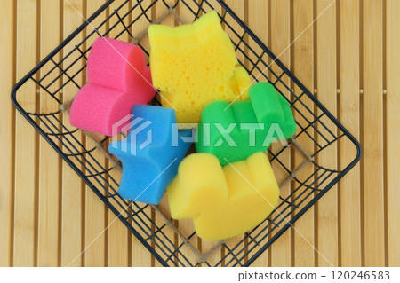 Baby washcloths in a metal basket on a wooden background. Baby care and hygiene. Wash and cleaning. Top view. Baby washcloths in a metal basket on a wooden background. Baby care and hygiene. Wash and cleaning. Top view. 120246583