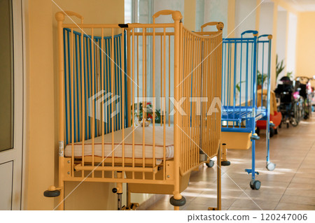 Empty baby cribs in a bright, inviting nursery hallway Empty baby cribs in a bright, inviting nursery hallway 120247006
