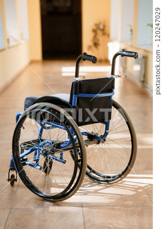 A Wheelchair in a Brightly Lit Hallway 120247029