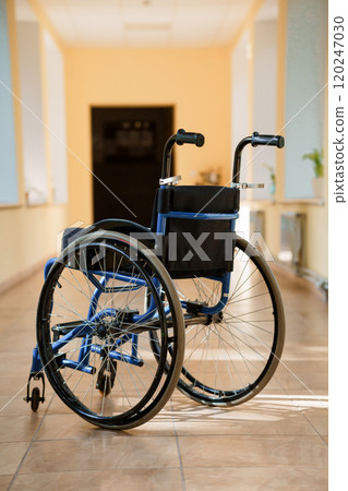 A Sturdy Blue Wheelchair in a Bright Indoor Space 120247030