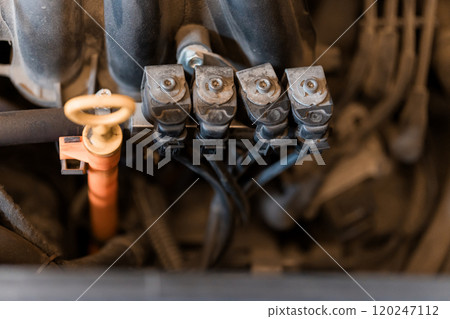 Close-Up of Engine Fuel Injector Assembly in a Vehicle Close-Up of Engine Fuel Injector Assembly in a Vehicle 120247112