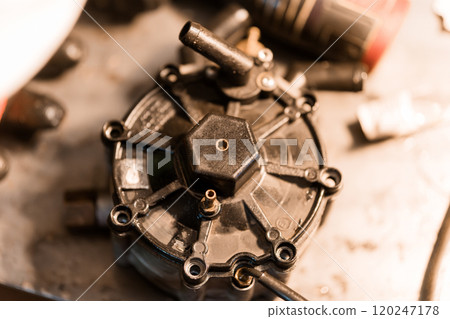 Detailed Close-up of an Automotive Fuel Pump Component on a Workshop Table Detailed Close-up of an Automotive Fuel Pump Component on a Workshop Table 120247178