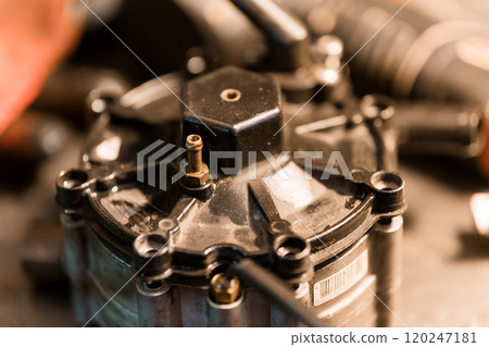 Detailed Close-Up of a Mechanical Fuel Pump Component on a Workbench 120247181