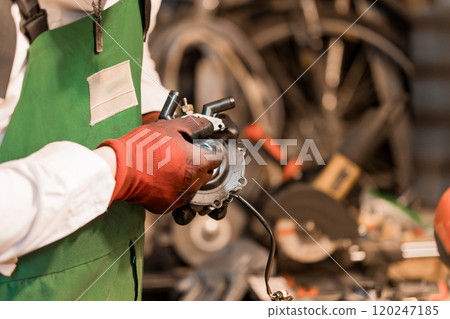 Skilled Mechanic Repairing Engine Component in Workshop Skilled Mechanic Repairing Engine Component in Workshop 120247185