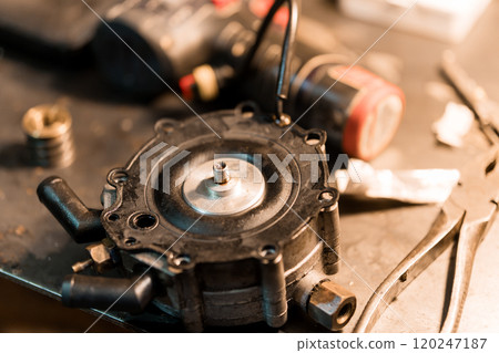 Close-Up of an Automotive Fuel Pump Component on a Workbench 120247187