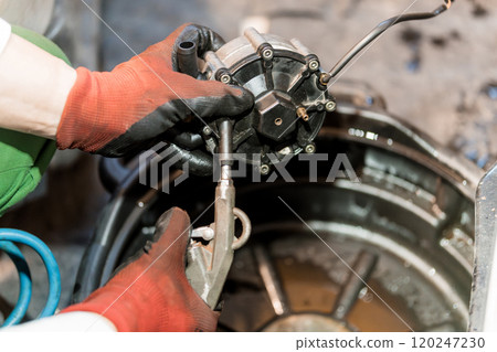Mechanical Maintenance: A Technician Repairs an Engine Component with Precision 120247230