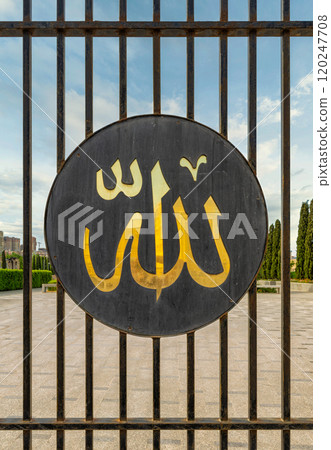 Side Entrance of Taza Pir Mosque in Baku, Azerbaijan Showcasing Intricate Gate Design and Religious Symbolism 120247708