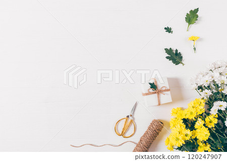 A white background with a box and scissors on it 120247907