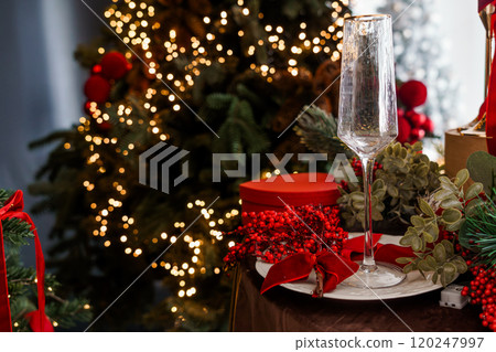 Elegant Holiday Table Setting with Christmas Decorations and Champagne Flute 120247997