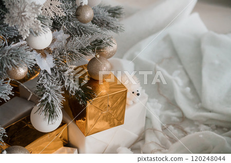 Cozy Holiday Scene with Christmas Tree, Gifts, and Soft Textiles 120248044