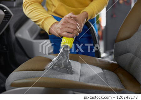 Cleaning car interior with washing vacuum cleaner Cleaning car interior with washing vacuum cleaner 120248178