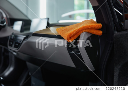 Rag towel on car dashboard for cleansing and detailing in auto service Rag towel on car dashboard for cleansing and detailing in auto service 120248210