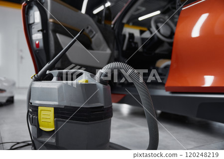 Closeup view on professional vacuum cleaner for car salon washing and cleaning Closeup view on professional vacuum cleaner for car salon washing and cleaning 120248219
