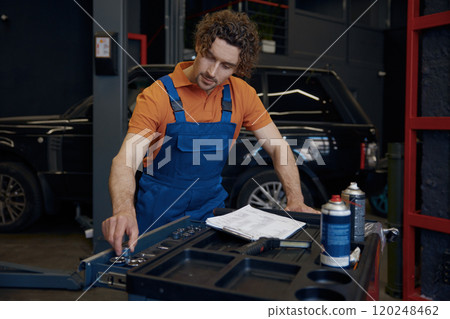 Male mechanic taking tools for work 120248462