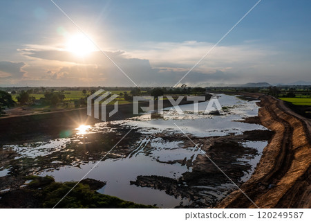 Construction dredges up for a canal and dam, to prevent a flood in the rainy season. Date on 14 May 2021 at Uthai Thani province, Thailand. 120249587
