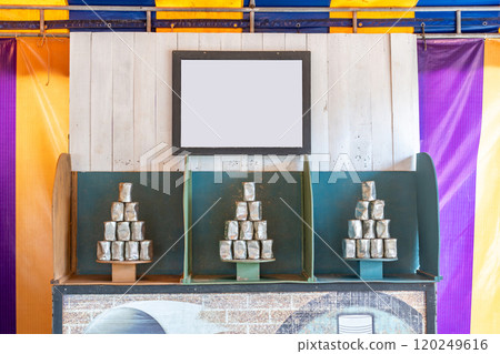 Tower of cans in front for throwing game at fun fair, Game shoot canned for outing party, Recreational pleasure. Tower of cans in front for throwing game at fun fair, Game shoot canned for outing party, Recreational pleasure. 120249616