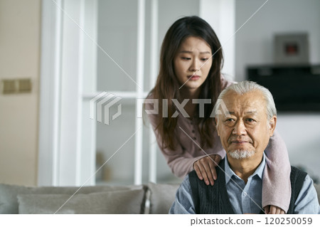 young asian adult daughter conforting senior father at home young asian adult daughter conforting senior father at home 120250059