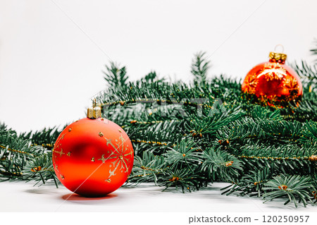 Christmas decoration with red balls and fir twigs on white background. Xmas background with baubles Christmas decoration with red balls and fir twigs on white background. Xmas background with baubles 120250957