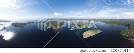 Aerial top view to island Kilpola overgrown with sparse trees in summer sunny day. Skerries Ladoga lake consisting of 650 rocky islands and steep cliffs. National park, Karelia, Russian nature. 120251413