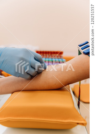 Healthcare professional preparing for a blood draw in a clinical laboratory setting 120251557