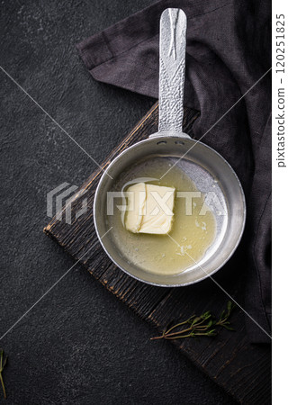 Melted butter on in iron pan Melted butter on in iron pan 120251825
