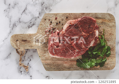 raw pork steak , pork neck, on a chopping board, marble table, top view, with spices and coriander, no people, 120251895