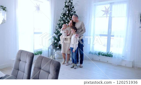 Large family stands near beautifully decorated Christmas tree holiday positive energy. Surrounded by festive glow of tree family celebrates holidays creating memories full of happiness affection. 120251936