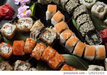Seth sushi on a black background.Menu of the Japanese restaurant. Several sushi close-ups.A view of the rolls from above. A view of the rolls from above. Traditional Asian Food Seth sushi on a black background.Menu of the Japanese restaurant. Several sushi close-ups.A view of the rolls from above. A view of the rolls from above. Traditional Asian Food 120252323