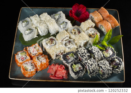 Menu of the Japanese restaurant. Several sushi laid out on a plate with ginger sauce wasabi. Rolls from above 120252332