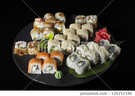 Seth sushi on a black background.Menu of the Japanese restaurant. Several sushi close-ups.A view of the rolls from above. A view of the rolls from above. Traditional Asian Food Seth sushi on a black background.Menu of the Japanese restaurant. Several sushi close-ups.A view of the rolls from above. A view of the rolls from above. Traditional Asian Food 120252346