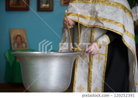 Baptismal font for babies. Preparing for children's baptism.The priest sanctifies the water for acceptance of faith 120252391