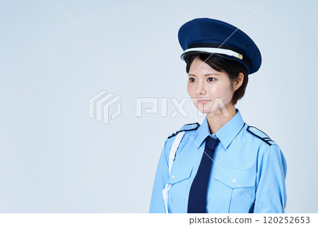 A woman in a security guard or police uniform 120252653