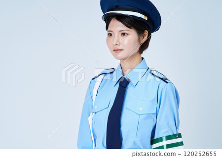 A woman in a security guard or police uniform A woman in a security guard or police uniform 120252655