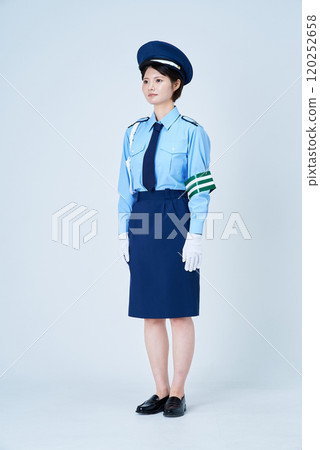 A woman in a security guard or police uniform A woman in a security guard or police uniform 120252658
