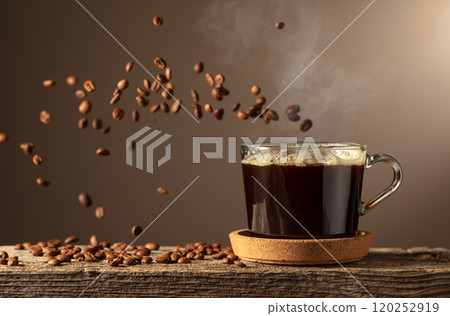 Black coffee in glass cup on an old wooden board. Black coffee in glass cup on an old wooden board. 120252919
