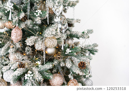 Decorated Christmas tree with frosted ornaments and warm lights isolated on white background Decorated Christmas tree with frosted ornaments and warm lights isolated on white background 120253318