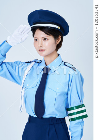 A woman in a security guard uniform saluting A woman in a security guard uniform saluting 120253341