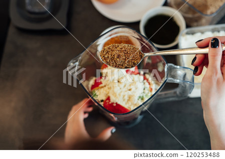 Close up woman adding flex seeds during making smoothie on the kitchen. Superfood supplement. Healthy detox vegan diet. Healthy dieting eating, weight loss program. Selective focus. Copy space Close up woman adding flex seeds during making smoothie on the kitchen. Superfood supplement. Healthy detox vegan diet. Healthy dieting eating, weight loss program. Selective focus. Copy space 120253488