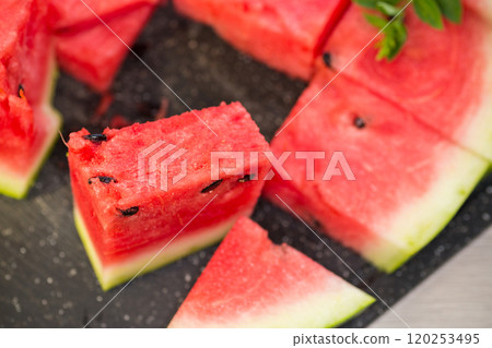 pieces of ripe red watermelon, close-up, on a board 120253495