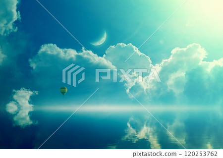 Amazing heavenly image - crescent and hot air balloon rising above serene sea, light from heaven. 120253762