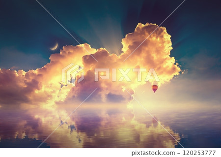 Amazing heavenly image, crescent, pink clouds and hot air balloon rising above serene sea, light from heaven. 120253777