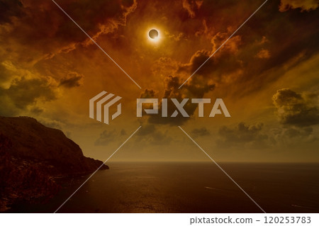 Total solar eclipse in dark red sky above sea and mountains Total solar eclipse in dark red sky above sea and mountains 120253783