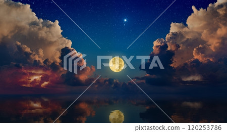 Full moon rising above serene sea in sunset sky with glowing clouds and bright stars Full moon rising above serene sea in sunset sky with glowing clouds and bright stars 120253786