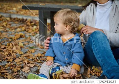 Child and parent enjoying a serene autumn day outdoors Child and parent enjoying a serene autumn day outdoors 120253981