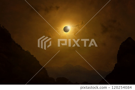 Total solar eclipse in dark red sky above mountains, mysterious phenomenon when Moon passes between planet Earth and Sun 120254084