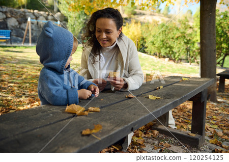 Mother and child enjoying a sunny autumn day in the park Mother and child enjoying a sunny autumn day in the park 120254125