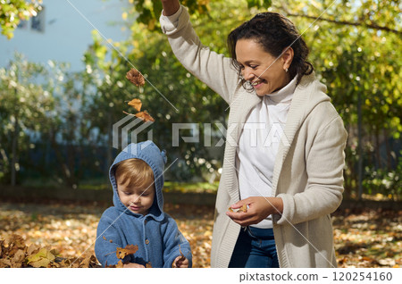 Joyful autumn day with mother playing in the park with child 120254160