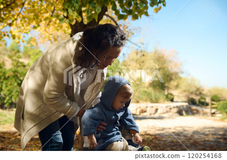 Mother and child enjoying a sunny autumn day outdoors Mother and child enjoying a sunny autumn day outdoors 120254168