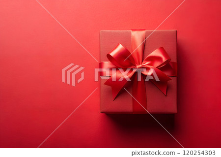 Red gift box on a red paper background with a red bow. Mockup, top view 120254303