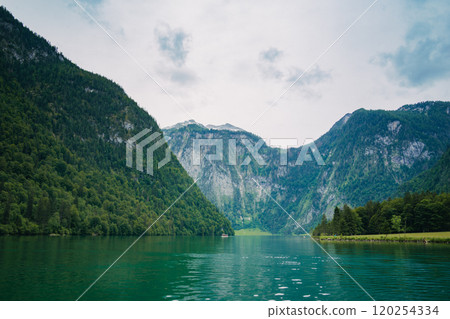 Konigssee Lake in Bavaria Germany with Church by the Lake White Boat Forested Mountain and Beautiful Sunny Trekking in Berchtesgaden German Alps. High quality photo 120254334